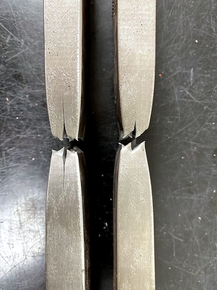 Two guided bend test specimens after testing.