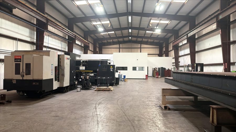 The machine shop bay with CNC machines set along the wall.