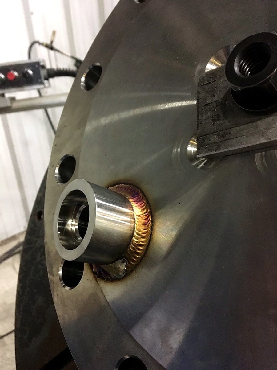 A close view of a machined bore welded into a thick plate.
