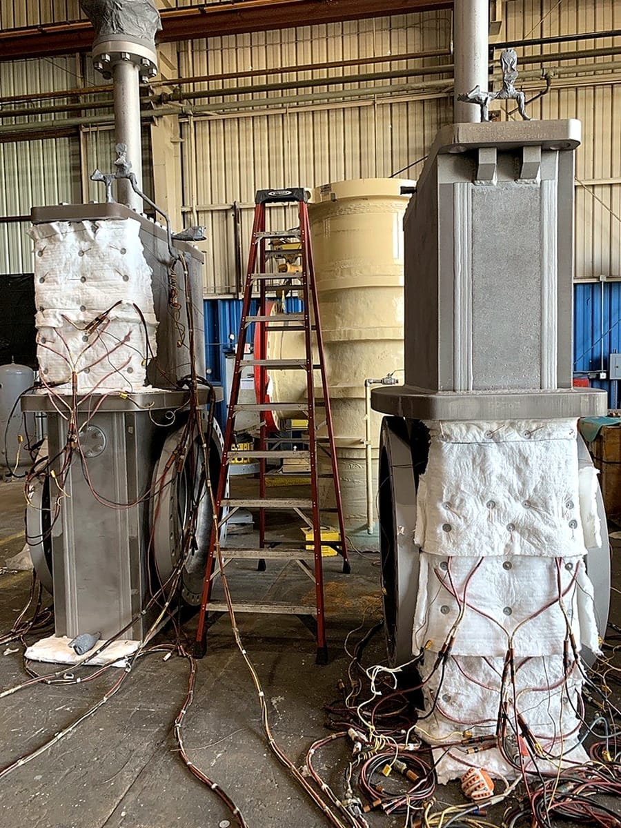 Two columns wrapped in ceramic pads and insulation, instrumented for a heat treatment cycle.